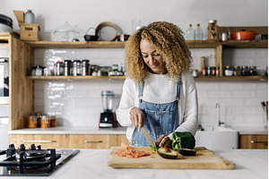 Woman preparing food in kitchen., a Person Photo by nunezimage