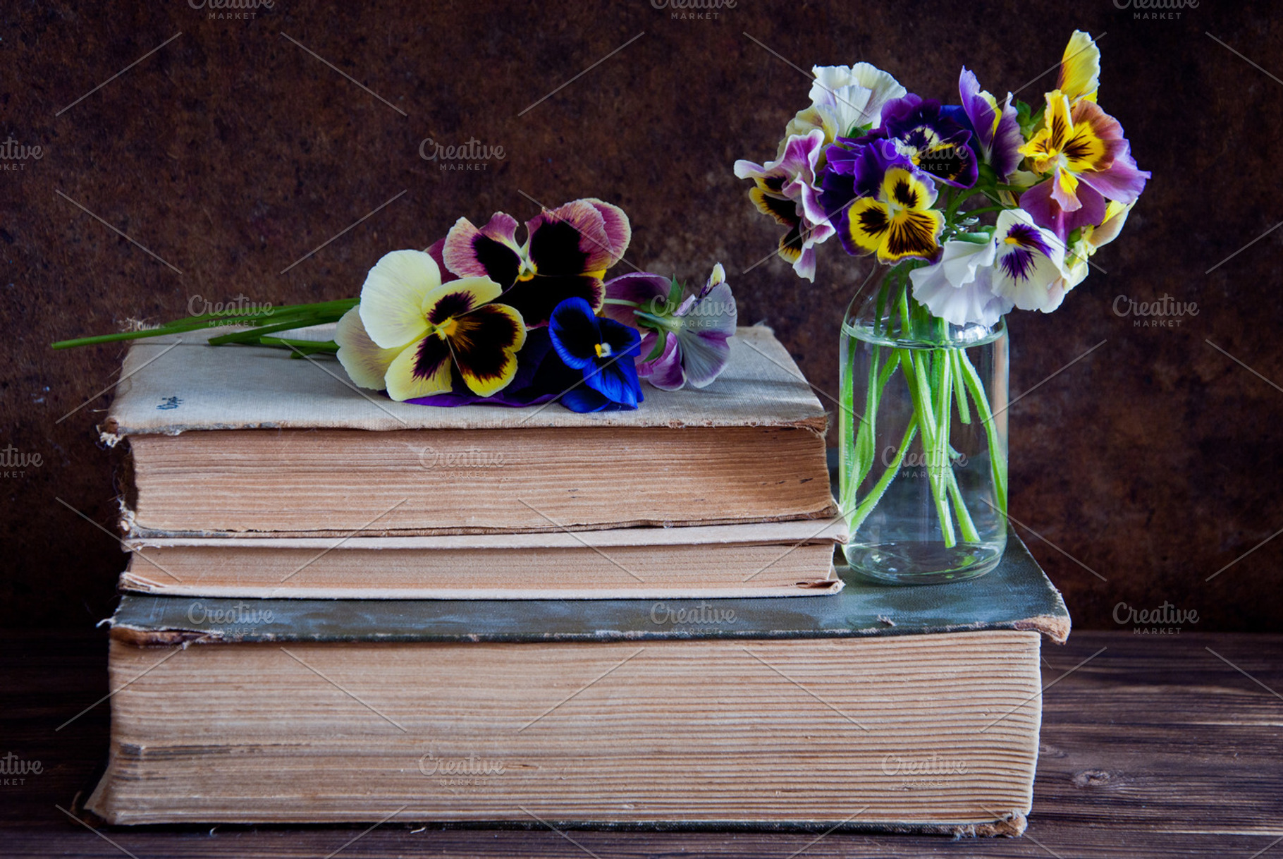 Pansies in glass bottles containing ancient, archives, and book, a Nature Photo by letterberry