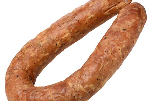 Smoked sausage with visible spices, isolated background. Delicio, a Food & Drink Photo by ndanko
