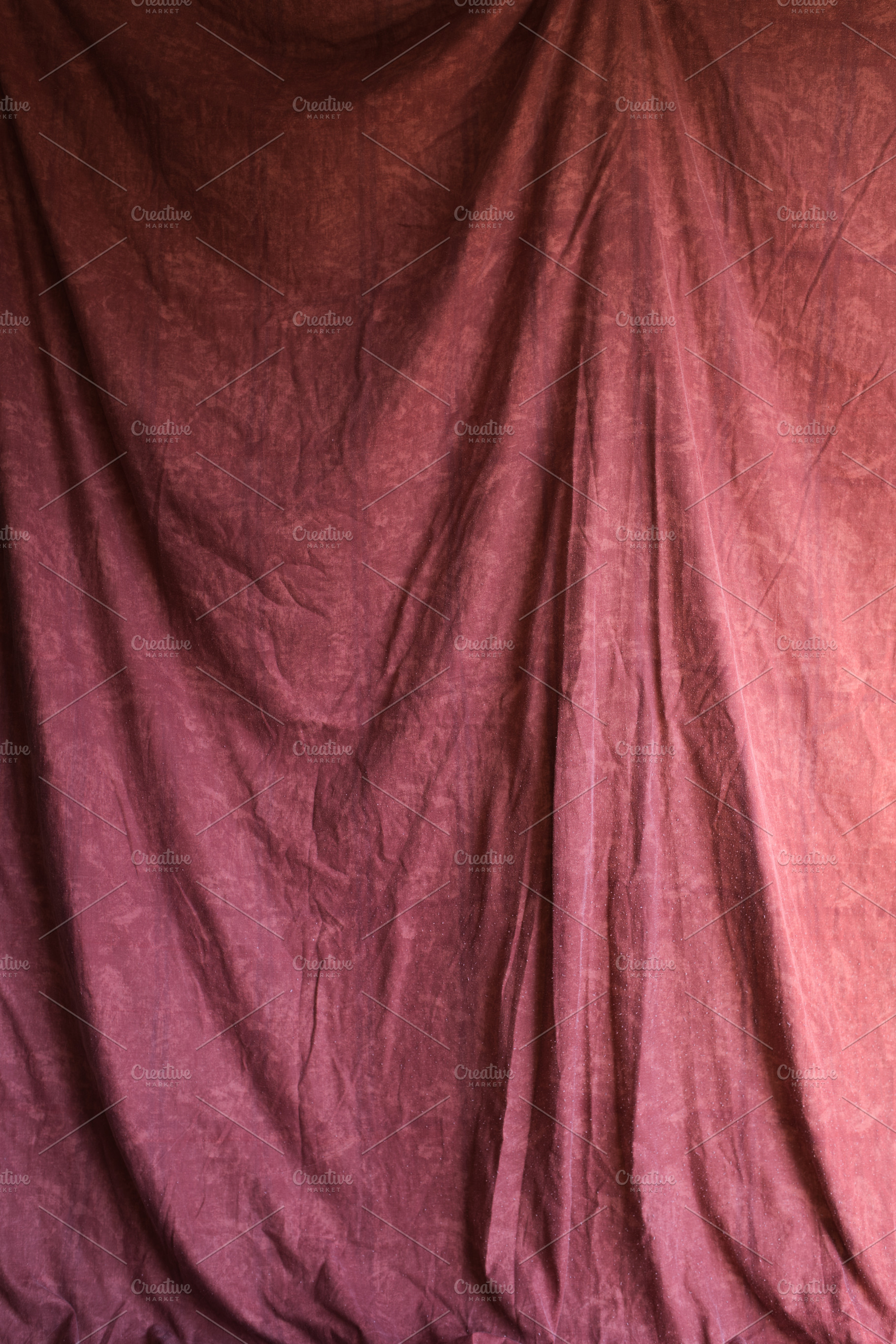 Maroon color crumpled fabric backgro, a Background Photo by alfernec