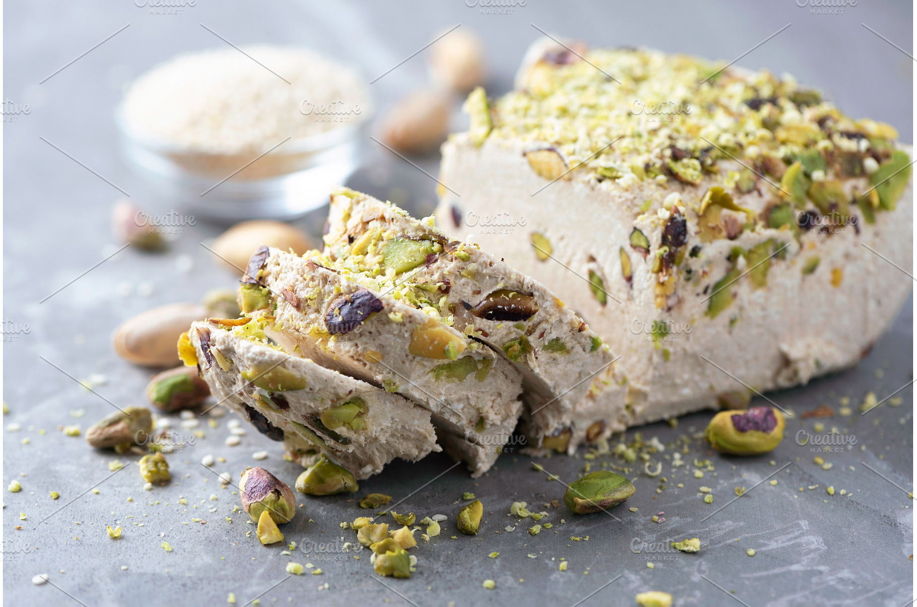 Sesame halva with pistachios on grey, a Food & Drink Photo by Enjoy Photo