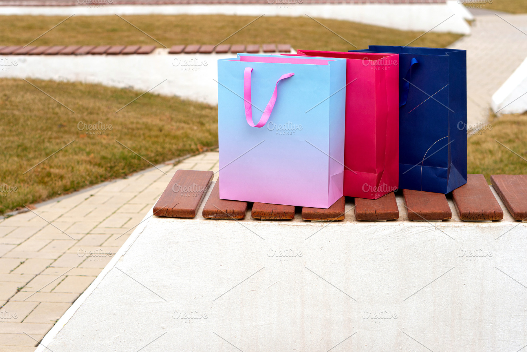 Three vibrant paper shopping bags, a Background Photo by Elena Vagengeim