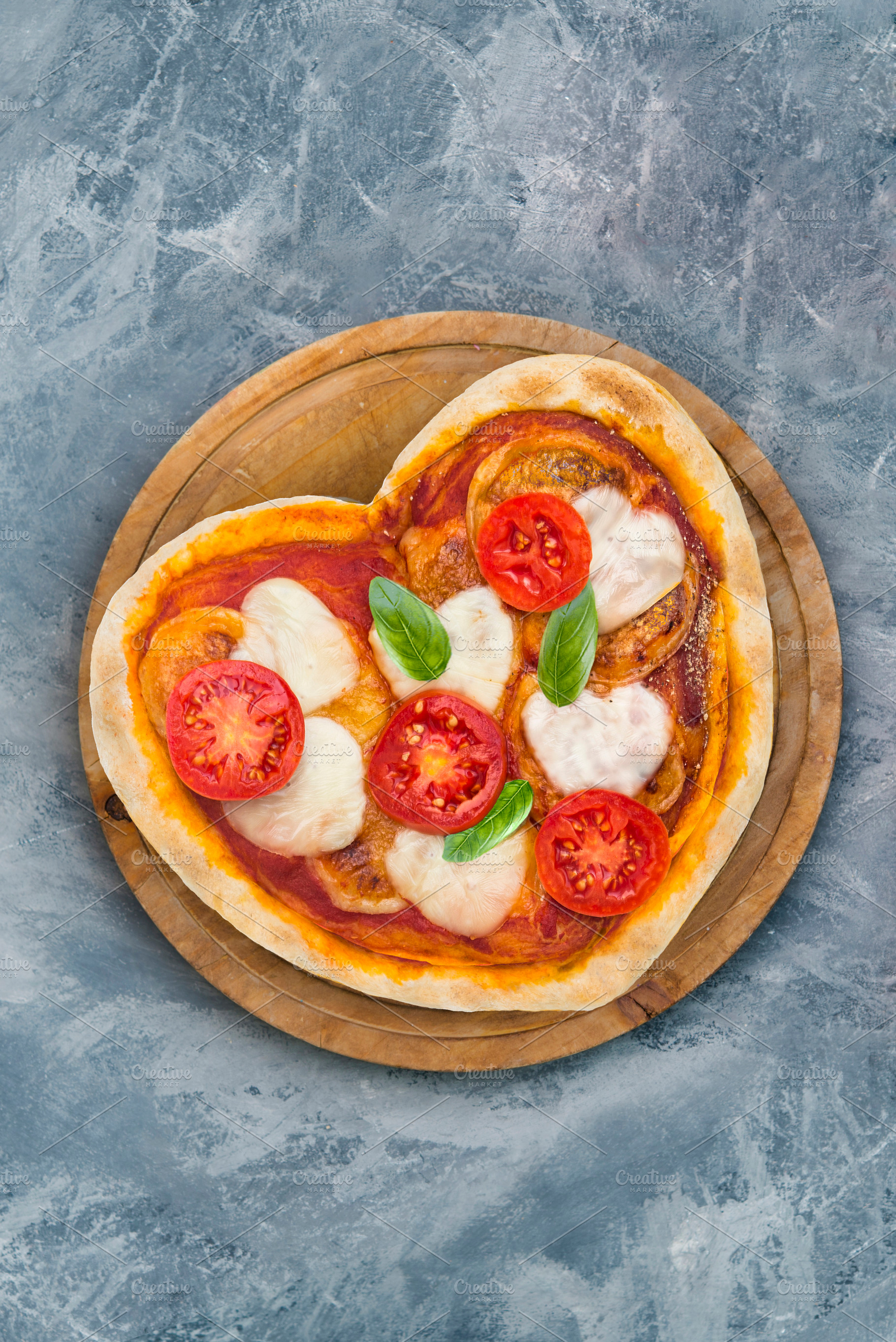 Margarita pizza with form of heart, a Food & Drink Photo by DalaiFood