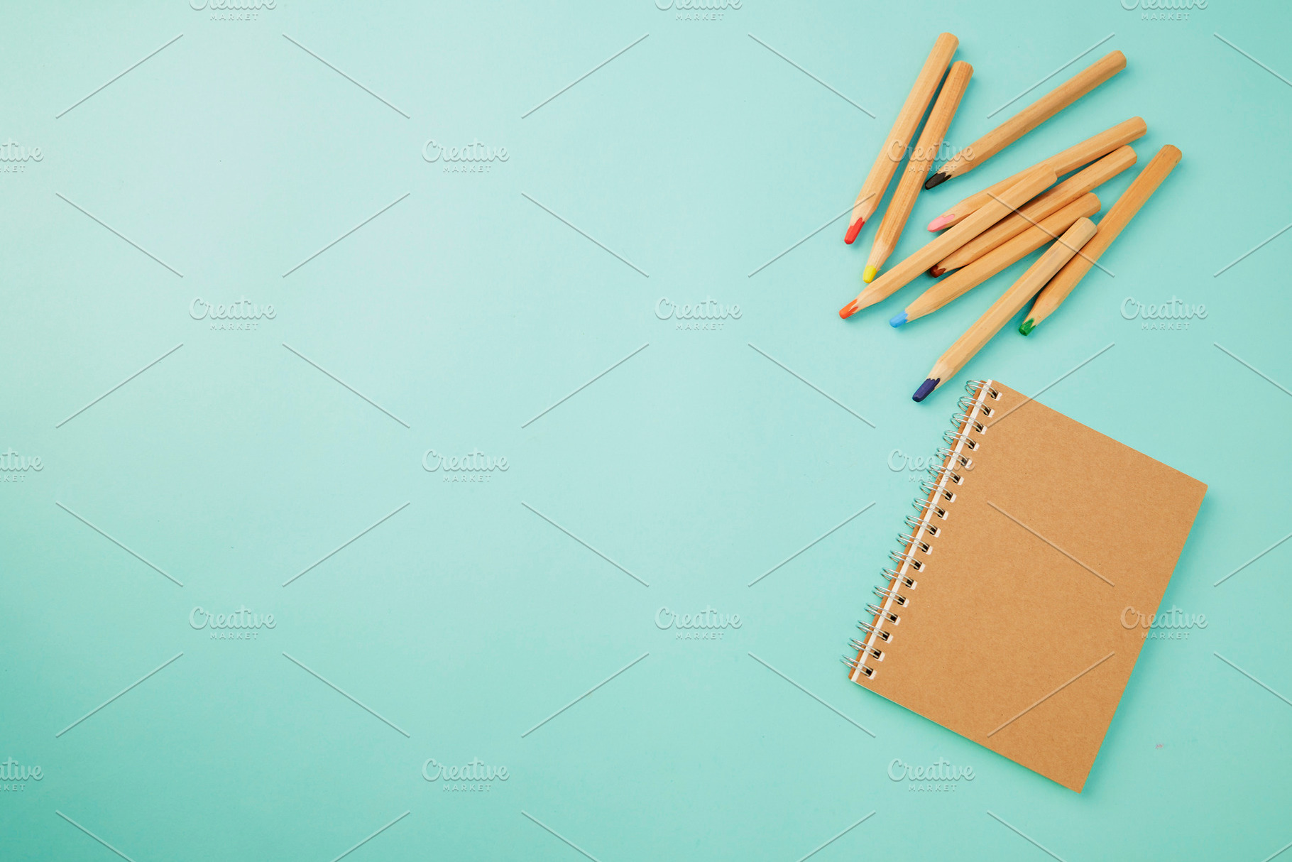 Crayon With a notebook on blue, a Background Photo by 1981 Rustic studio kan
