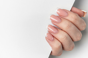 Woman hand showing french manicure on white background, a Beauty & Fashion Photo by Olena Rudo
