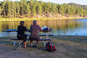 Couple relaxing at lake stock photo containing beautiful and calm