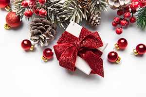 Christmas giftbox with red ribbon and winter holiday decorations, a Holiday Photo by Olena Rudo
