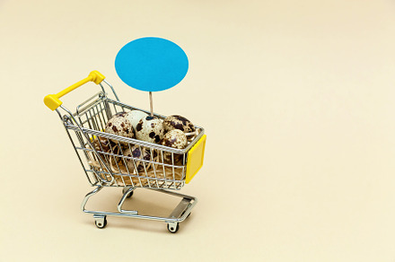 Metal shopping cart on a beige background., a Food & Drink Photo by Photostock