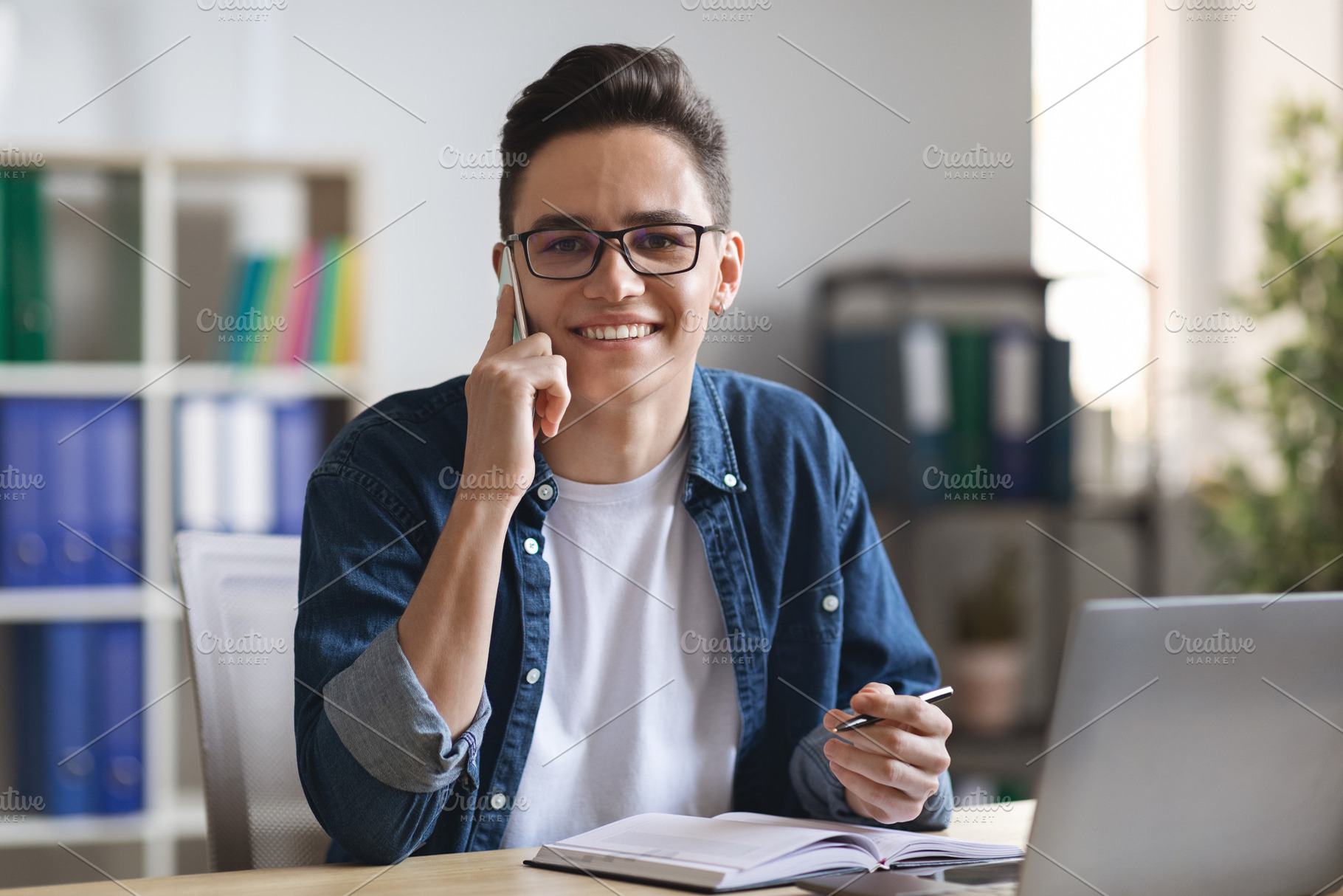 Business Communication. Male Office Employee Talking On Cellphone And Taking No, a Photo by Prostock-Studio
