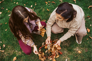 Grandmother and girl picking autumn