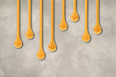 Yellow ink drops on light concrete wall. Horizontal wallpaper, a Background Photo by GoodGoods