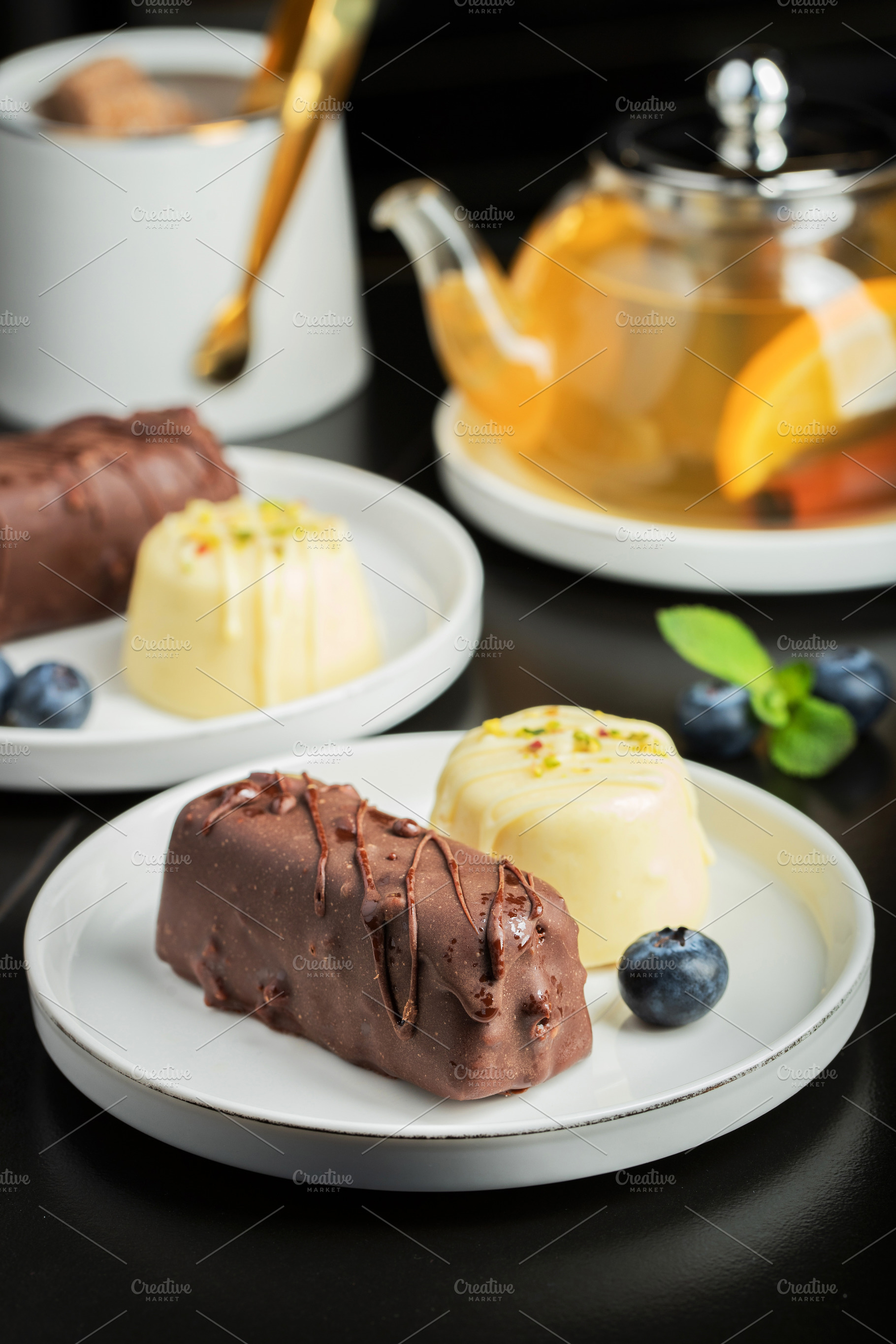 Delicious glazed curd snacks with fresh blueberries and mint on, a Food & Drink Photo by Budarinphoto