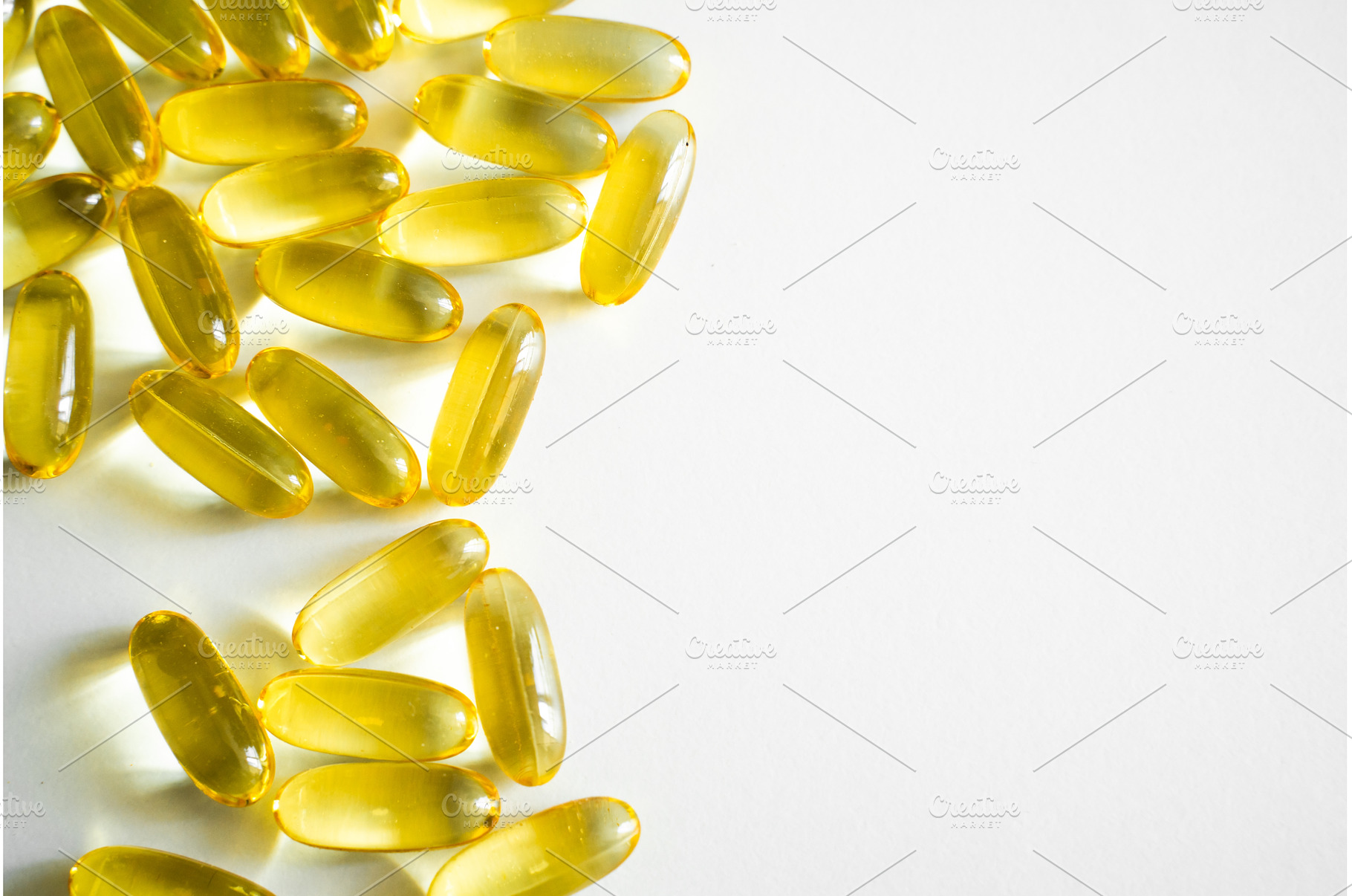 Bright yellow omega-3 capsules, a Health & Medical Photo by volodymyrshtun13795