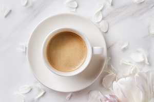 Espresso coffee cup and fresh pastel tulips creating a beautiful, a Photo by Studio ANNA