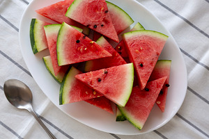 Raw Organic Watermelon Slices on a Plate, top view. Flat lay, ov, a Food & Drink Photo by LiudmylaChuhunova