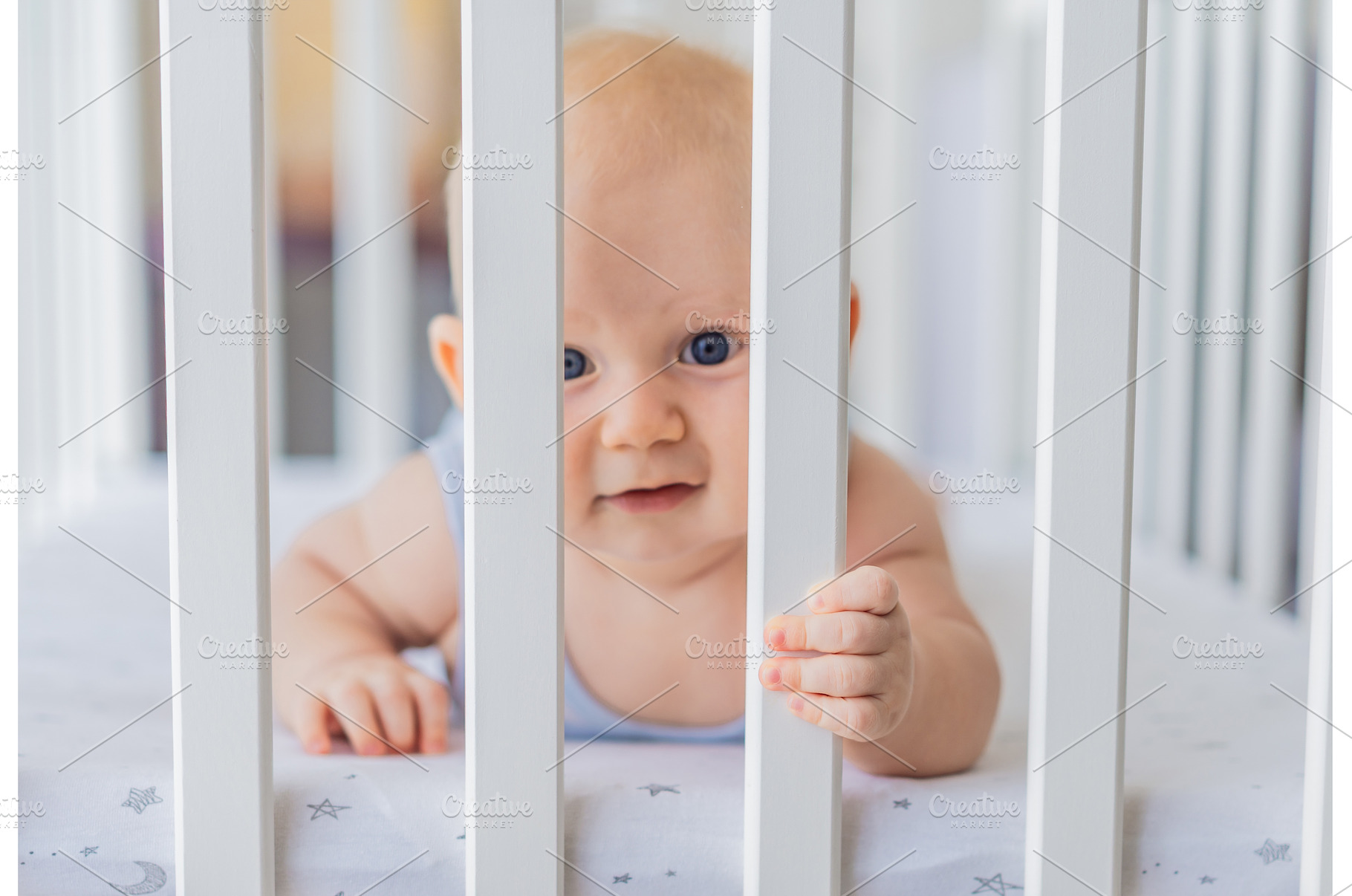 Sad baby looking through the bars of, a Person Photo by Elizaveta Galitskaya