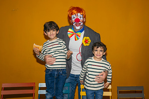 Clown celebrating birthday party with happy children, a Person Photo by karrastock