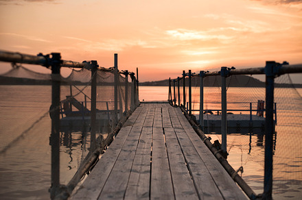 Wooden bridge on the beach featuring wooden, sunset, and sea, a Nature Photo by MONNKA
