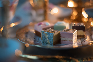 Petit fours arranged on an elegant serving plate, creating a fes, a Photo by Studio ANNA