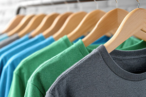 Colorful t-shirts hanging on rack, a Photo by Beautiful things