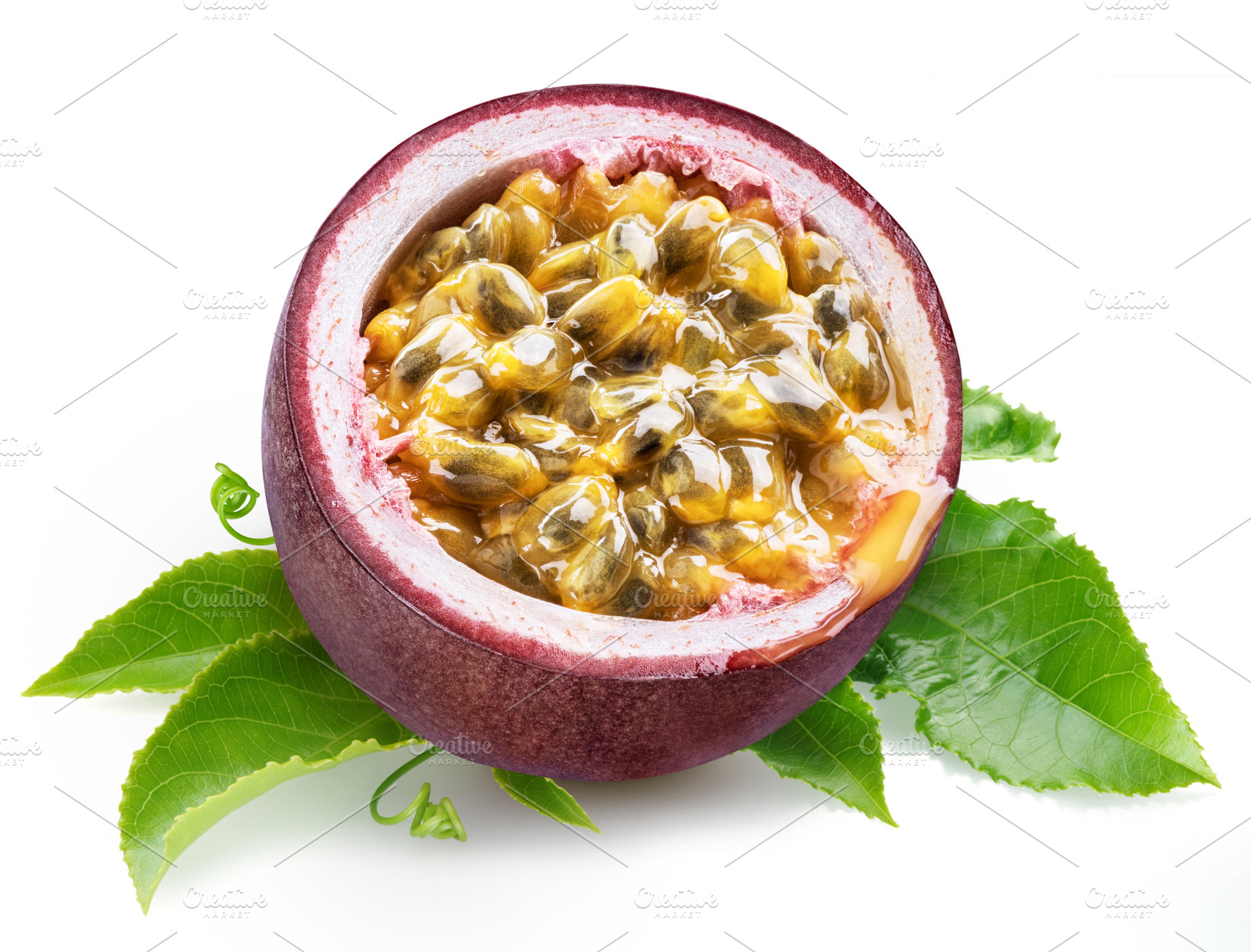 Dark purple passion fruit half with seedy interior laying on gre, a Food & Drink Photo by Volff