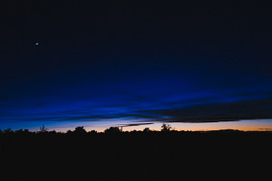 Desert sunset with crescent moon containing sky, sunset, and dusk