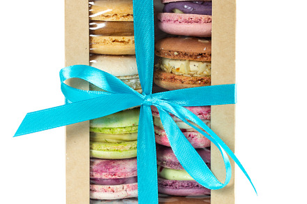 Different colorful macarons in box