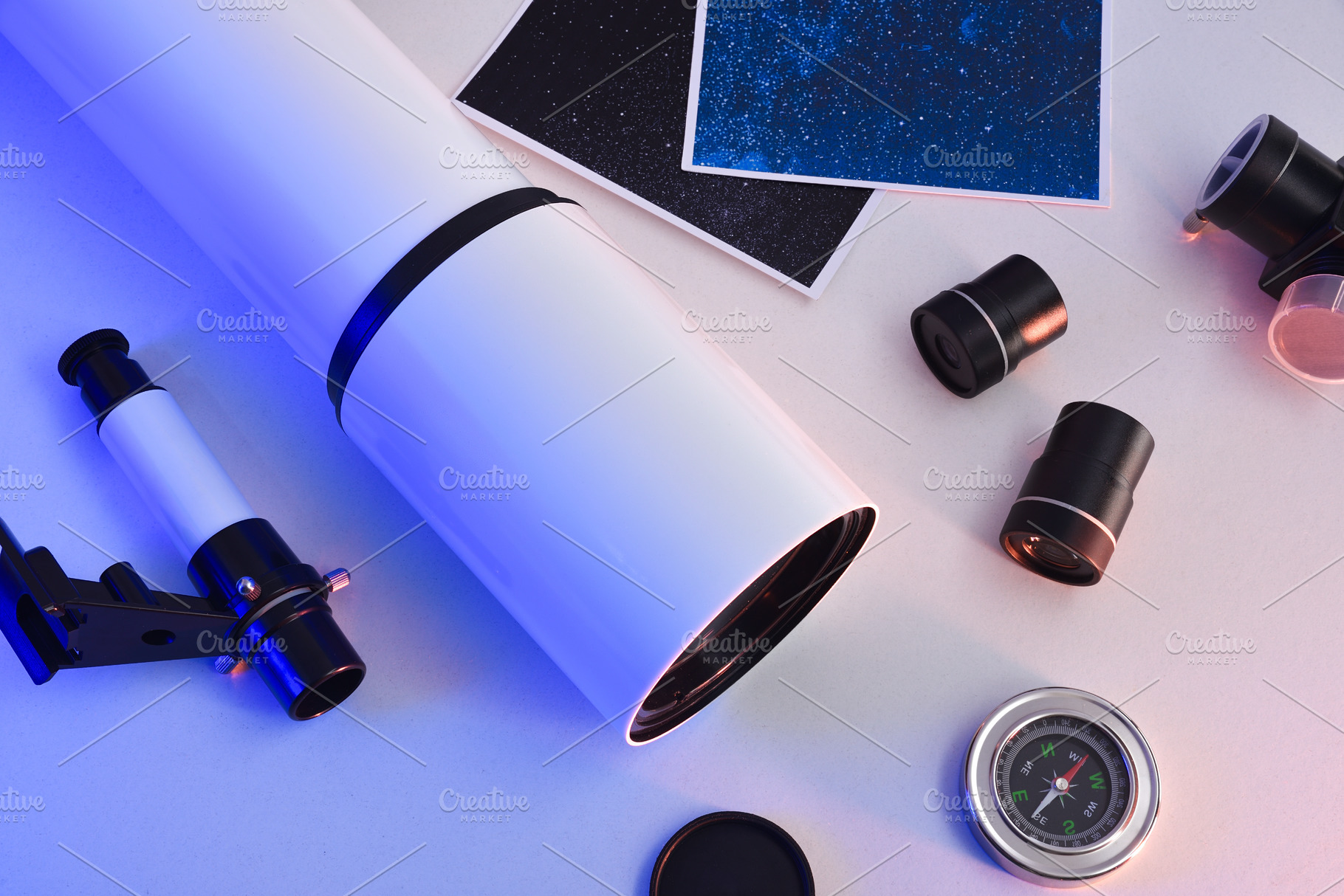 Telescope different parts spread out on table illuminated blue l, a Sports & Recreation Photo by Davizro's Market