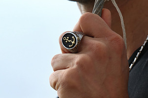 Sailor showing a maritime ring with an anchor and a rope, an Abstract Photo by Antonio Gravante Market