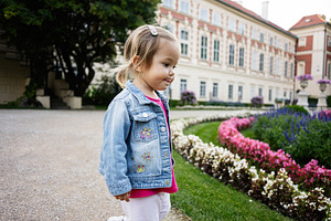 Young child exploring garden at historic architecture in Lancut, Poland, a Photo by AS photostudio