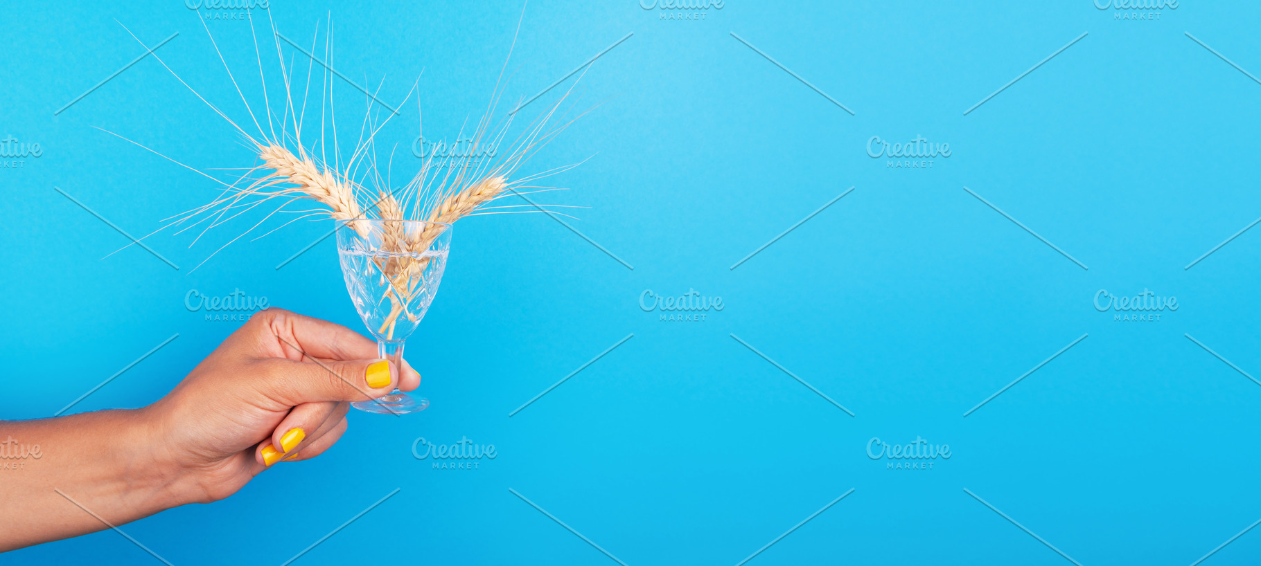 Female hand with yellow nails holding a crystal glass with wheat, a Food & Drink Photo by Ales Munt
