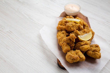 Homemade crispy japanese fried chicken Karaage on a rustic woode, a Food & Drink Photo by LiudmylaChuhunova