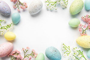 Pastel easter eggs and spring flowers creating border, a Holiday Photo by Olena Rudo