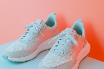 Pink sneakers on color background, a Photo by Dvoevnore photos