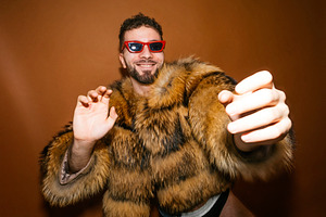 Expressive man wearing fur coat celebrating gay pride