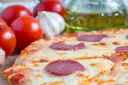 Homemade pepperoni pizza on a wooden board, ready to eat, a Food & Drink Photo by iuliia_n