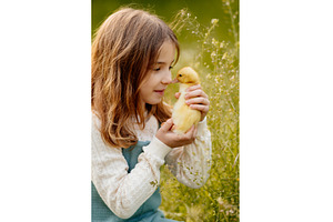 Girl holding duckling in palms., an Animal Photo by HalfPoint