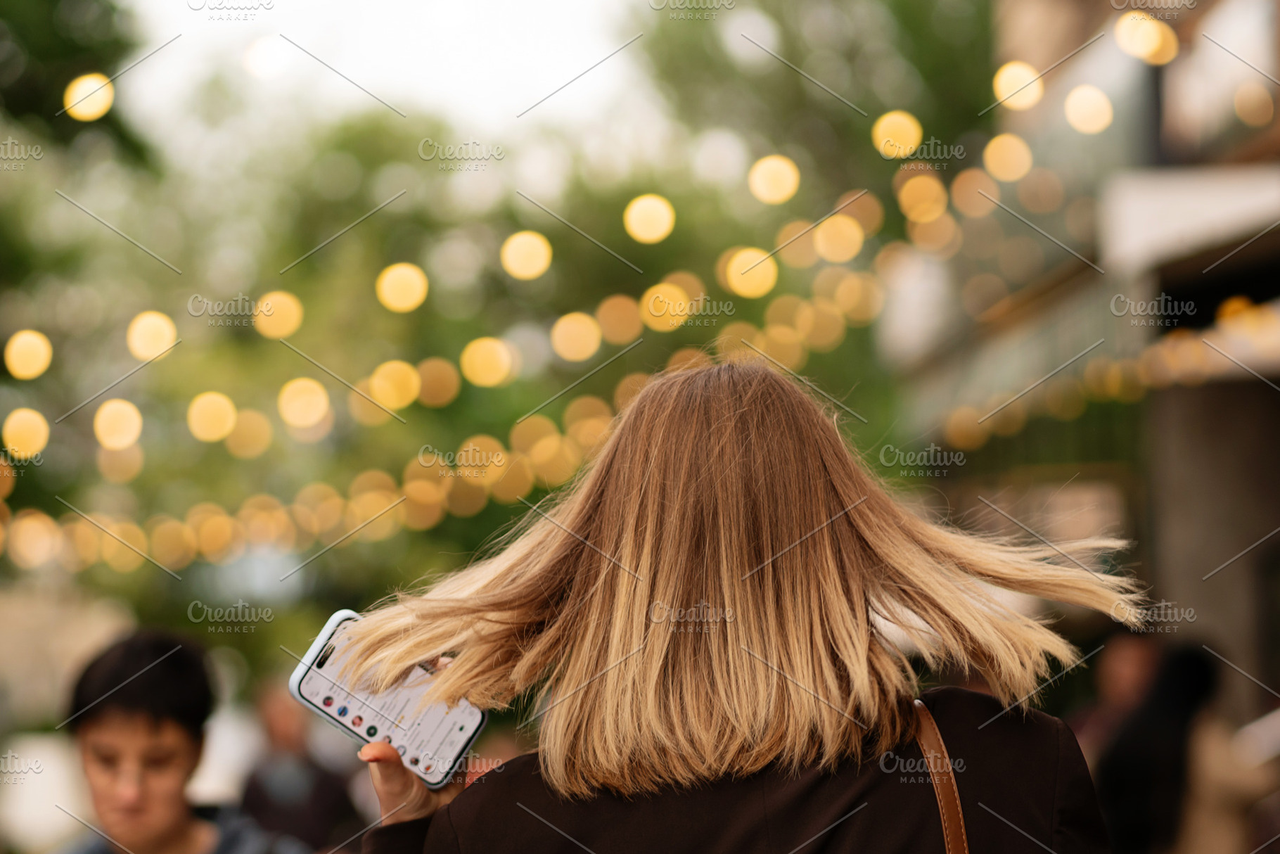 Blonde woman holding smartphone, a Person Photo by Elena Vagengeim