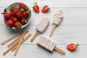 Homemade strawberry ice cream popsicles with fresh fruit, a Food & Drink Photo by Olena Rudo