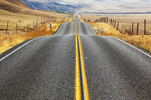 Magnificent american road featuring hill, fence, and road