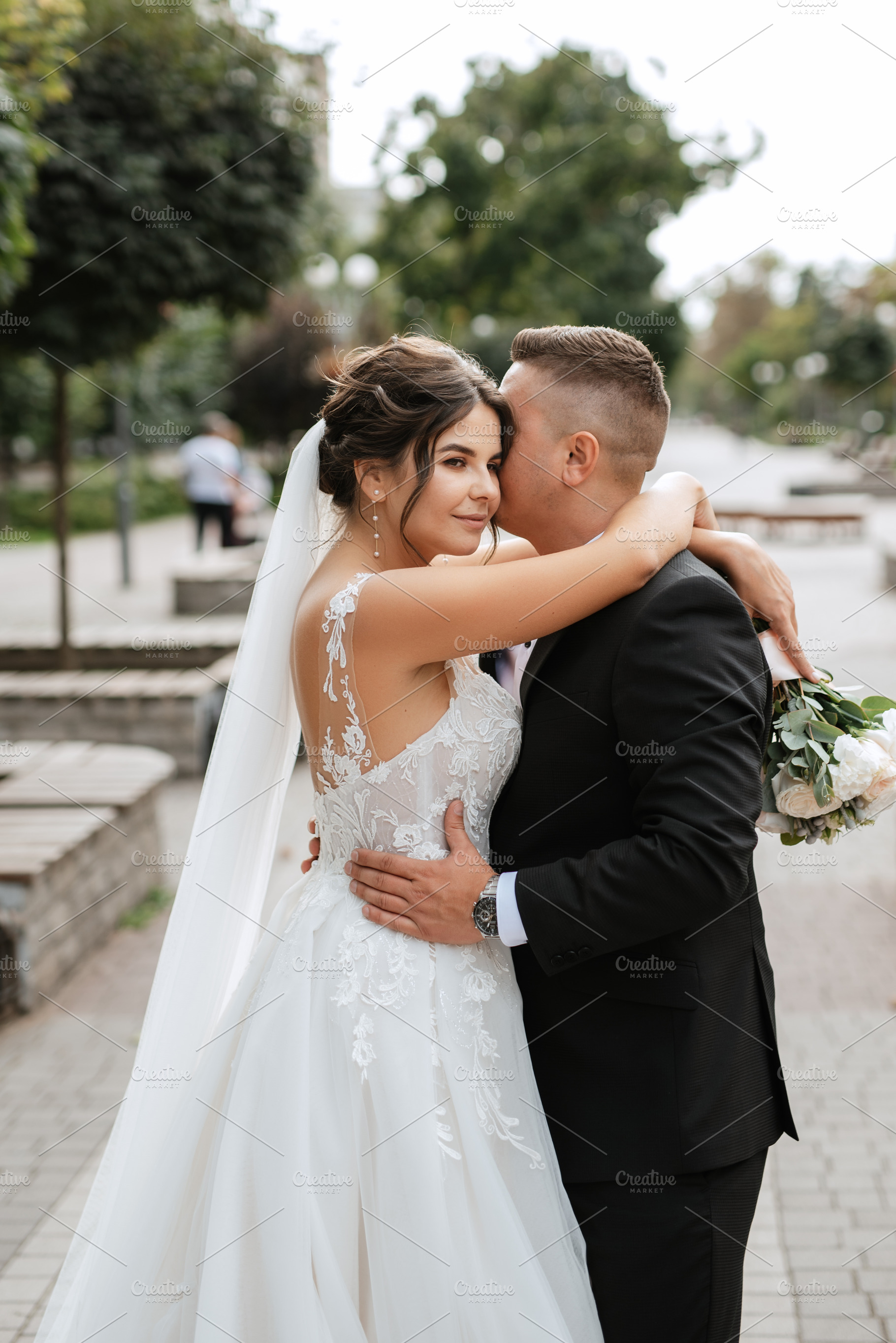 the groom in a brown suit and the bride in a white dress, a Person Photo by Weddings, People, Travel