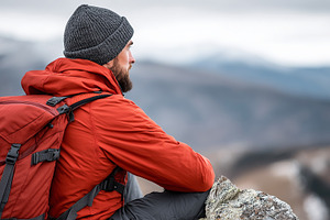Man in red jacket, beanie, backpack, a Person Photo by MistyDay