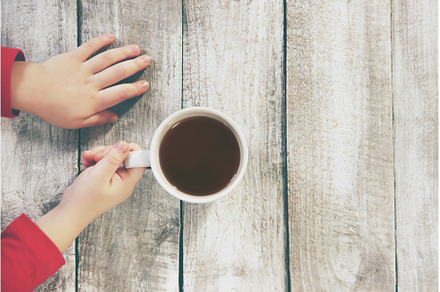A cup of tea in the hands of a child, a Food & Drink Photo by yanadjana