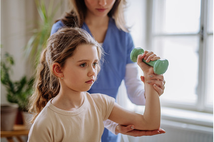 Little girl doing exercise with a, a Health & Medical Photo by HalfPoint