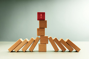 Red wooden block with exclamation mark standing among dominoes, a Photo by salmon.black