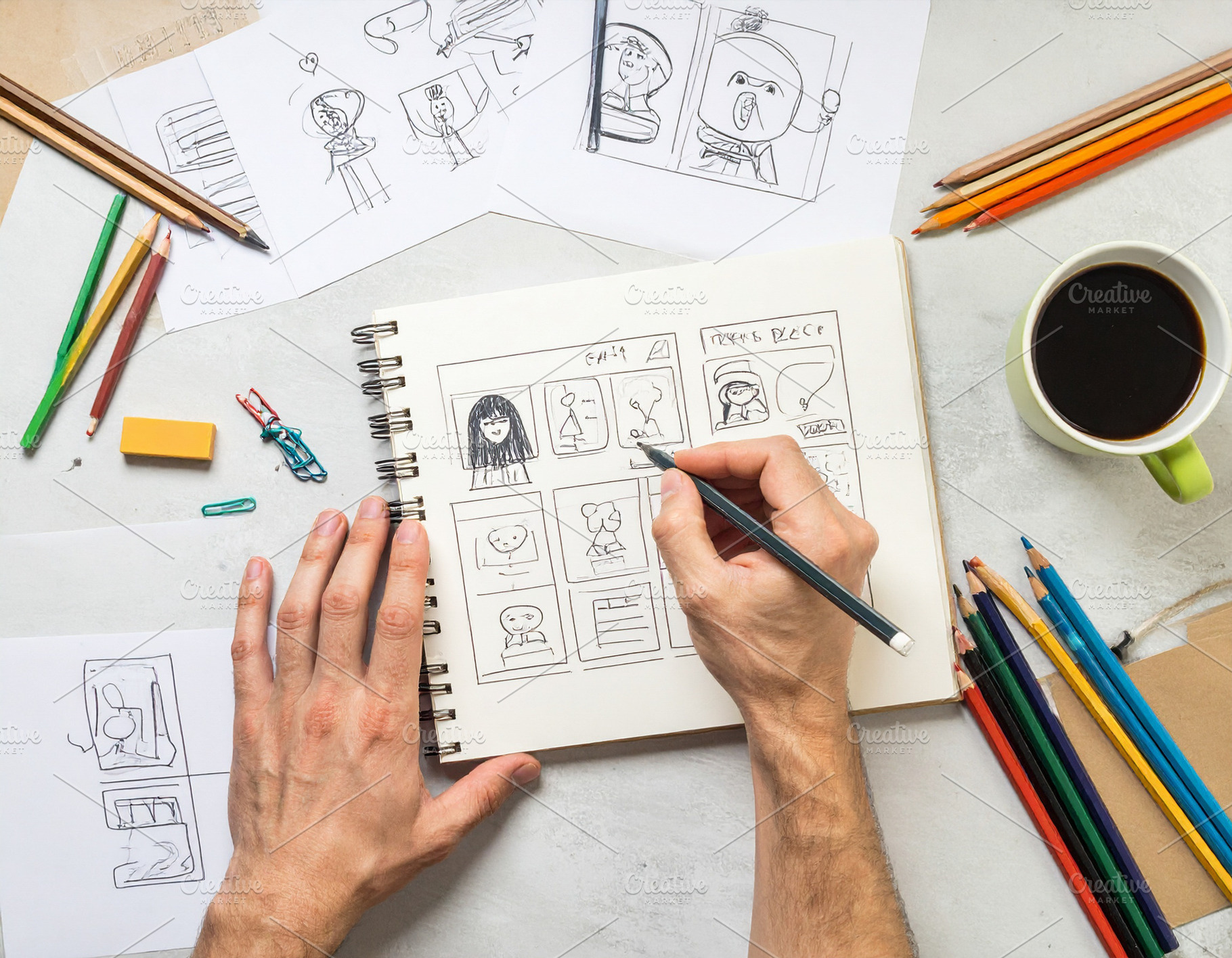 Persons hands drawing on a table a storyboard in a notebook, an Arts & Entertainment Photo by DanFLCreativo