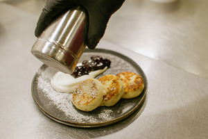 Cooking breakfast syrniki roasted chef sour cream, a Food & Drink Photo by Photo Drive Studio
