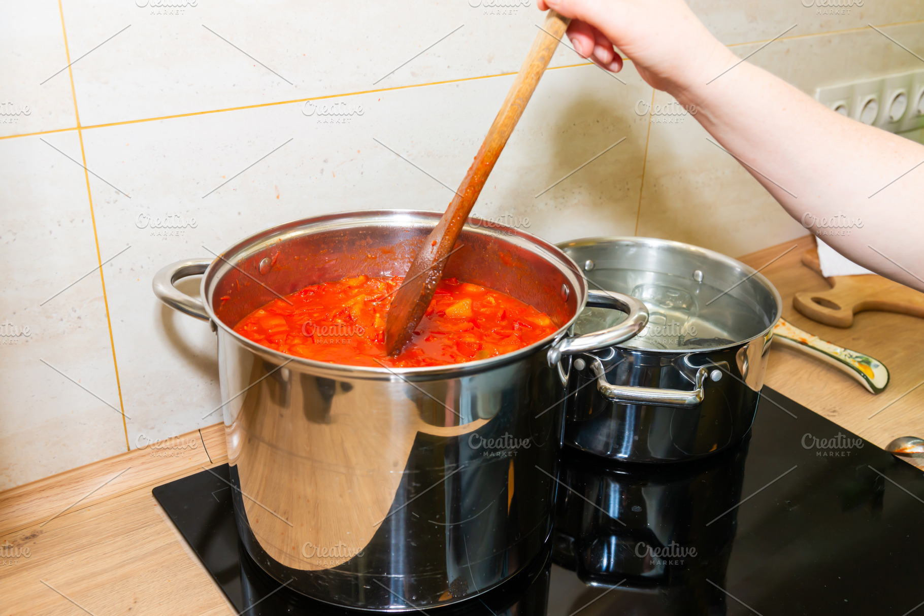 Cooking tomato sauce in big cooking pot, a Food & Drink Photo by Vapi