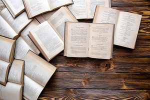 Opened books lying on the wooden table with pocketbook study stock photo, a School & Education Photo by velychko.ua