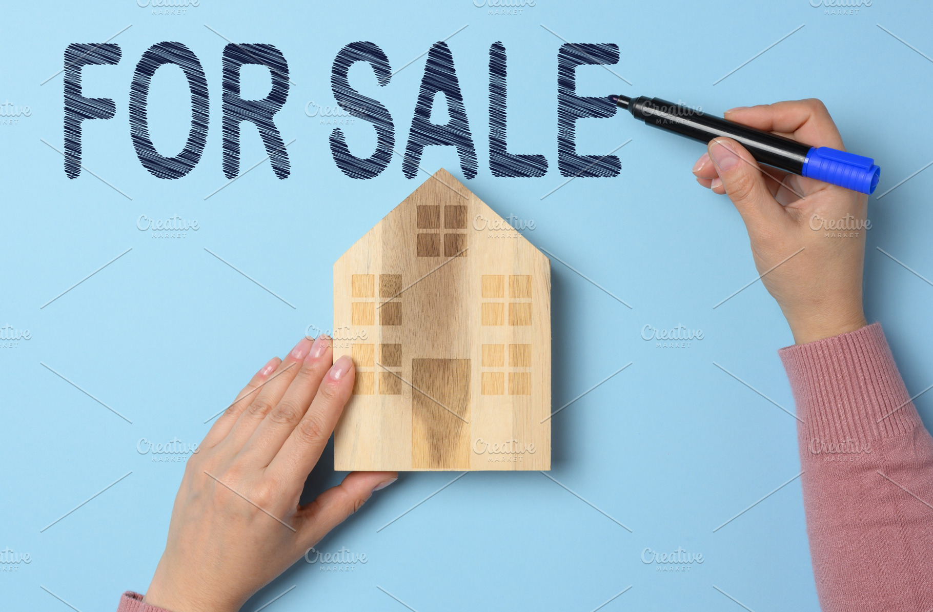 Wooden house and for sale sign on blue background. Conceptual im, a Business Photo by ndanko